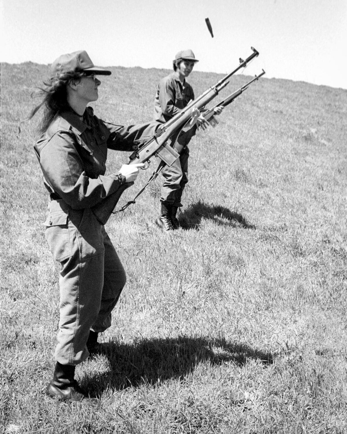 In the hills above Chorro reservoir, Toni Cortner, rifle in hand on maneuvers with ROTC cadets in her squad. Cal Poly ROTC cadets train on April 6, 1974.