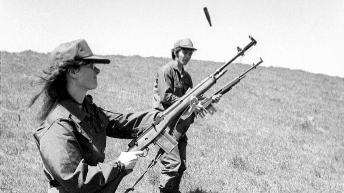 In the hills above Chorro reservoir, Toni Cortner, rifle in hand on maneuvers with ROTC cadets in her squad. Cal Poly ROTC cadets train on April 6, 1974.