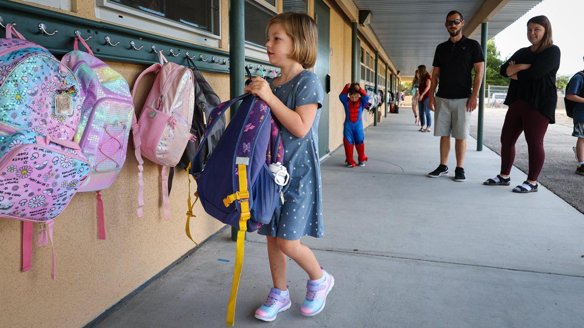 Ryan Anderson, 6, hangs up her first-grade backpack on Monday, Aug. 14, 2023, on the first day of school at Santa Margarita Elementary as parents Sean and Amber Anderson watch. Little brother Connor, 3, celebrated his birthday by wearing a Spider-Man suit. The campus welcomed 294 students as back-to-school festivities got underway in San Luis Obispo County.