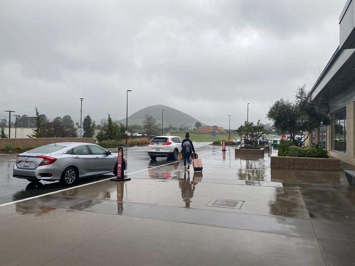 Travelers were soaked by rain at the San Luis Obispo County Airport on Monday, Jan. 9, 2023.