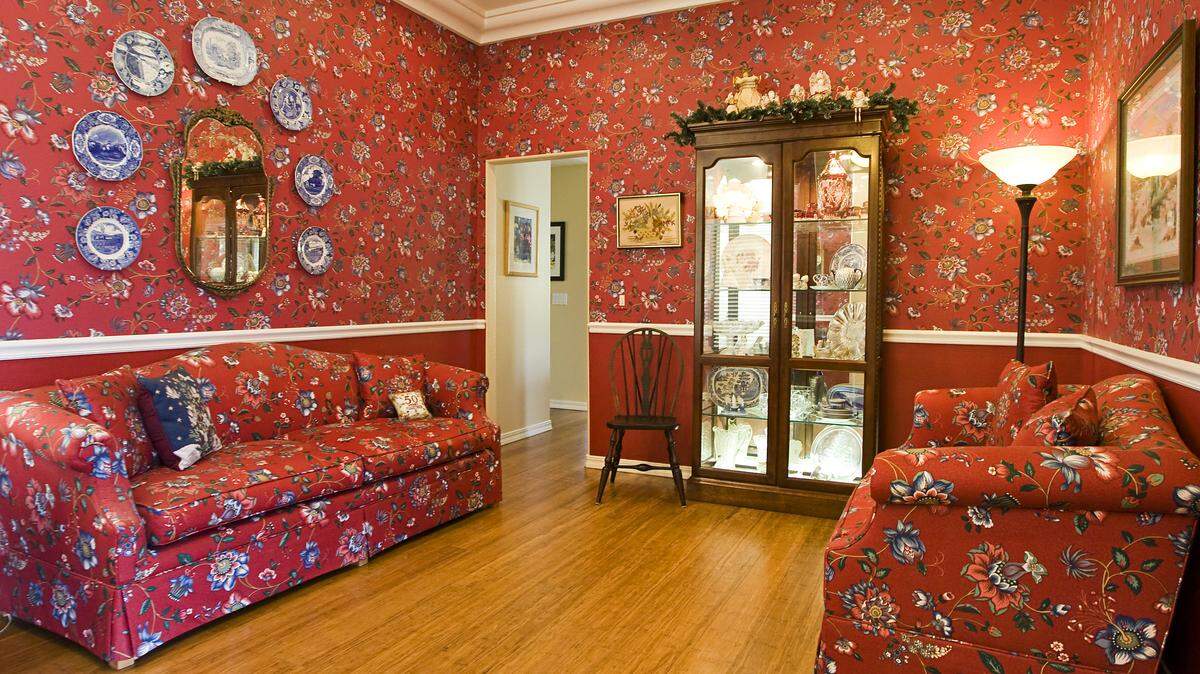 The red palette of the sitting room is a backdrop for the family’s Christmas collectibles.