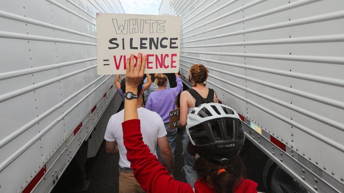 Tuesday’s No Justice No Peace protest began at Mitchell Park and moved to marching the streets of San Luis Obispo. Here, marchers move between blocked semi trucks on Highway 101.