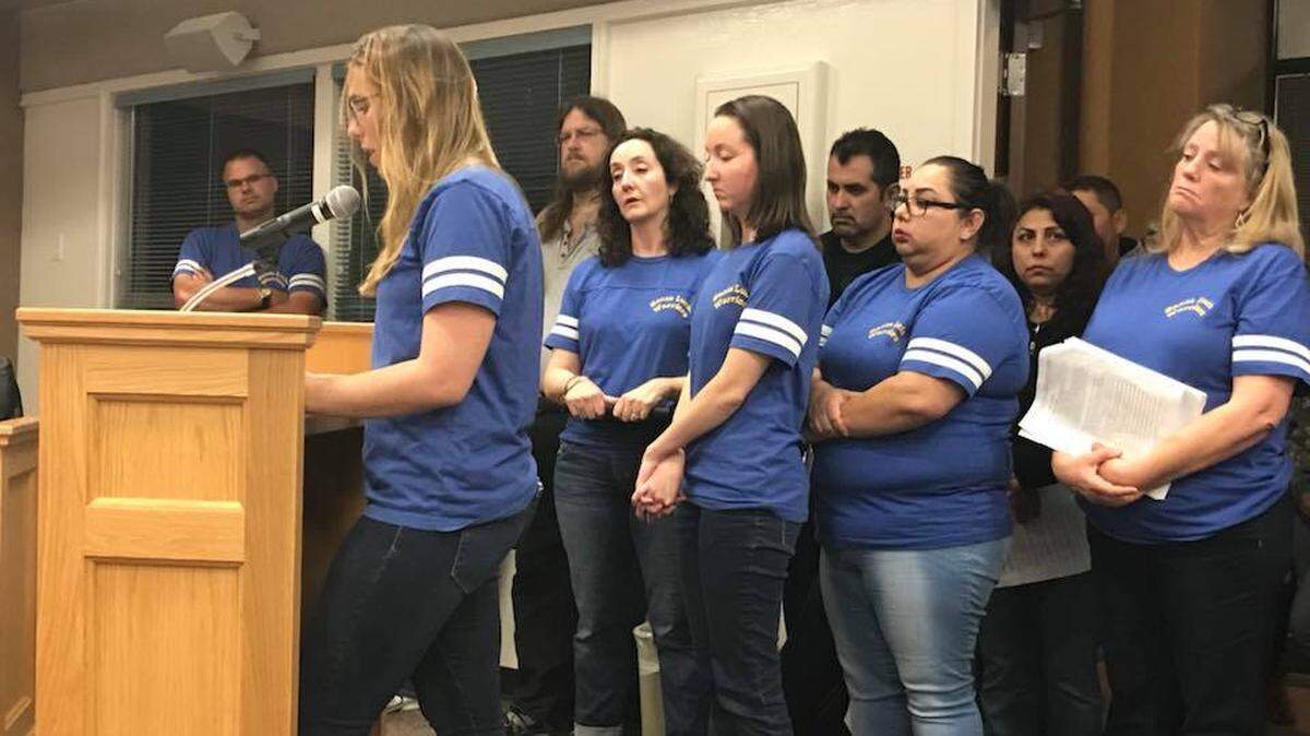 Santa Lucia Middle School teacher Emily Mills addresses the school board Thursday, April 12, expressing concerns about teacher reassignments. Members of the Santa Lucia staff dressed in matching blue shirts to express solidarity.