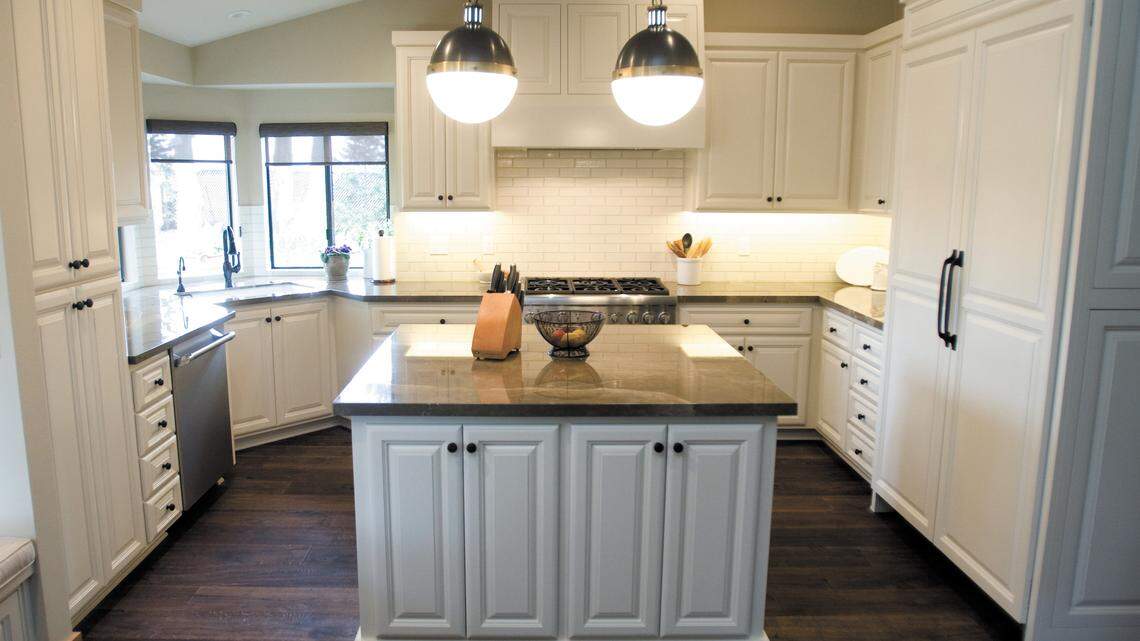 Cream-colored cabinetry by Barnick Wood Design and new lighting gives the kitchen an airy, inviting feel.