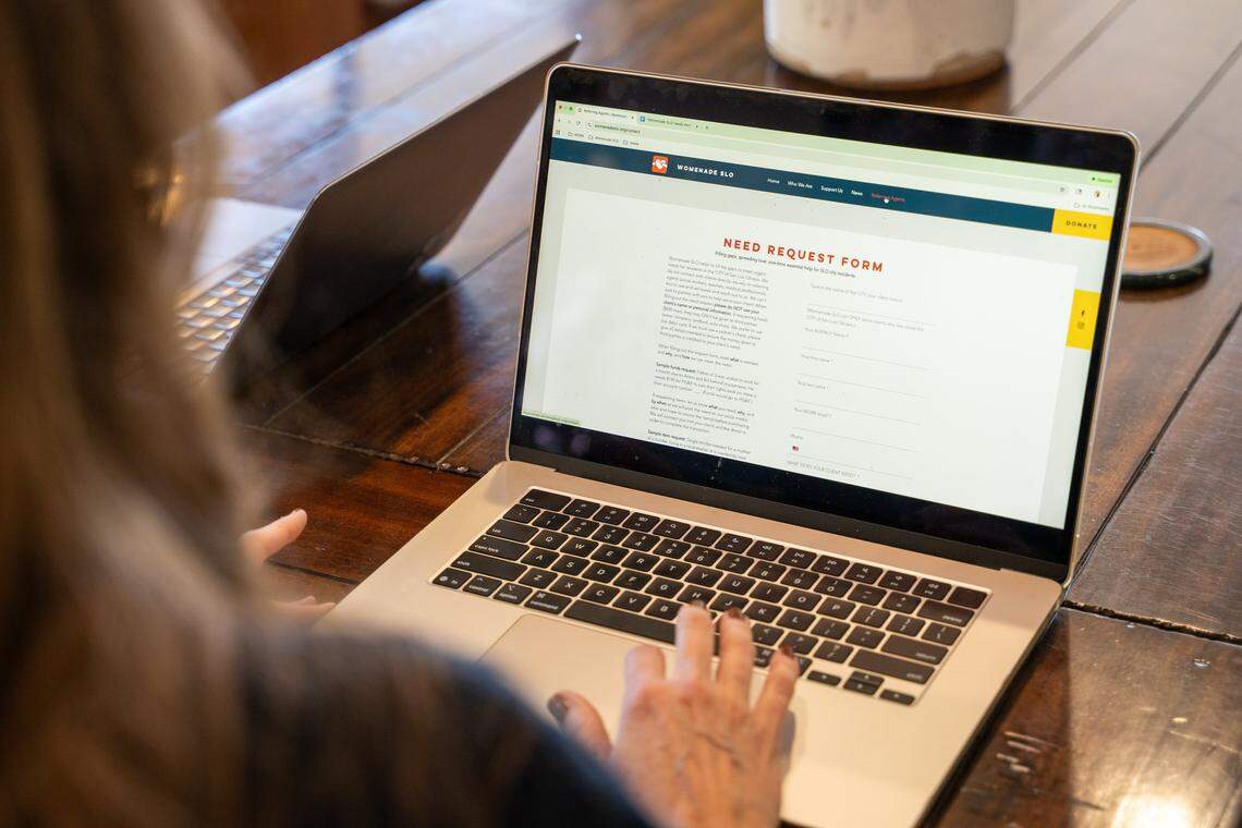 Womenade SLO executive director Elaine Stewart fills out a Need Request Form on Saturday, Dec. 6, 2025. Womenade SLO was founded in April 2025 as a successor to the Womenade organization that served San Luis Obispo County from 2003 to 2019.