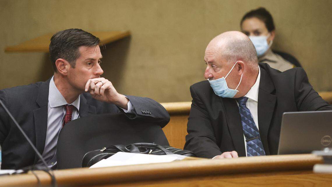Deputy District Attorney Chris Peuvrelle, left, talks to San Luis Obispo County Sheriff’s Office Det. Clint Cole during a Aug. 3, 2021, preliminary hearing for Paul and Ruben Flores, accused of murdering and concealing the body of missing Cal Poly freshman Kristin Smart.