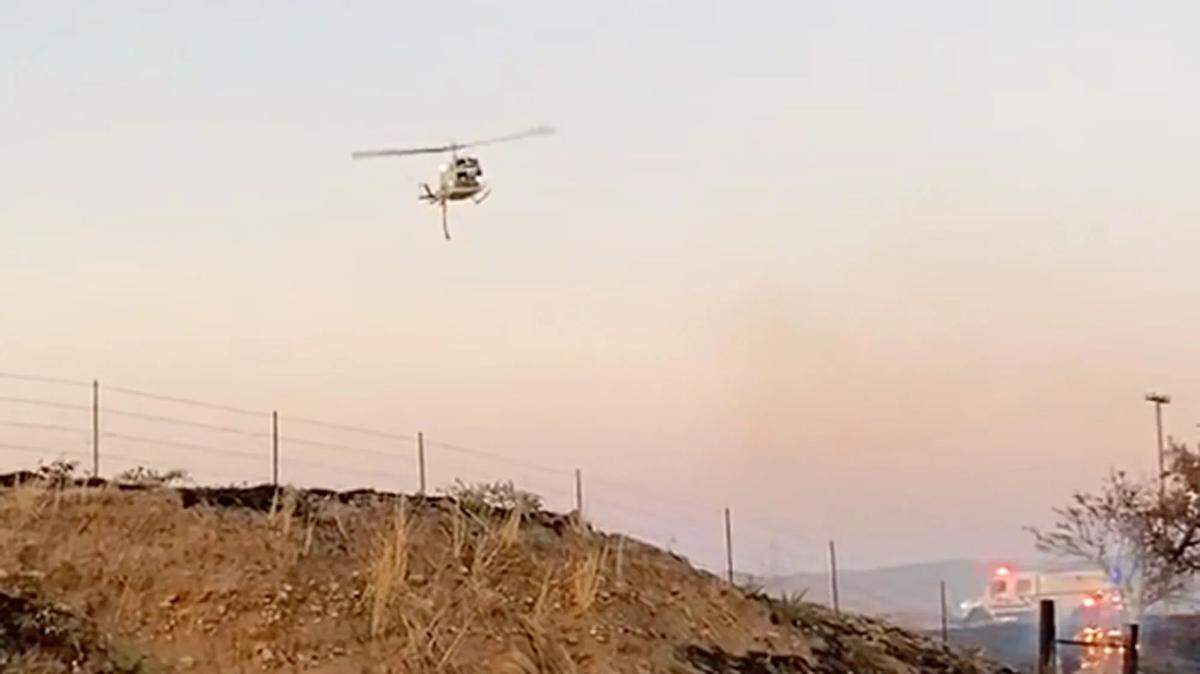 A Santa Barbara County helicopter was called in to help douse a vegetation fire that broke out on Saturday, July 29, 2023, after a fatal crash on Highway 166 east of Santa Maria.