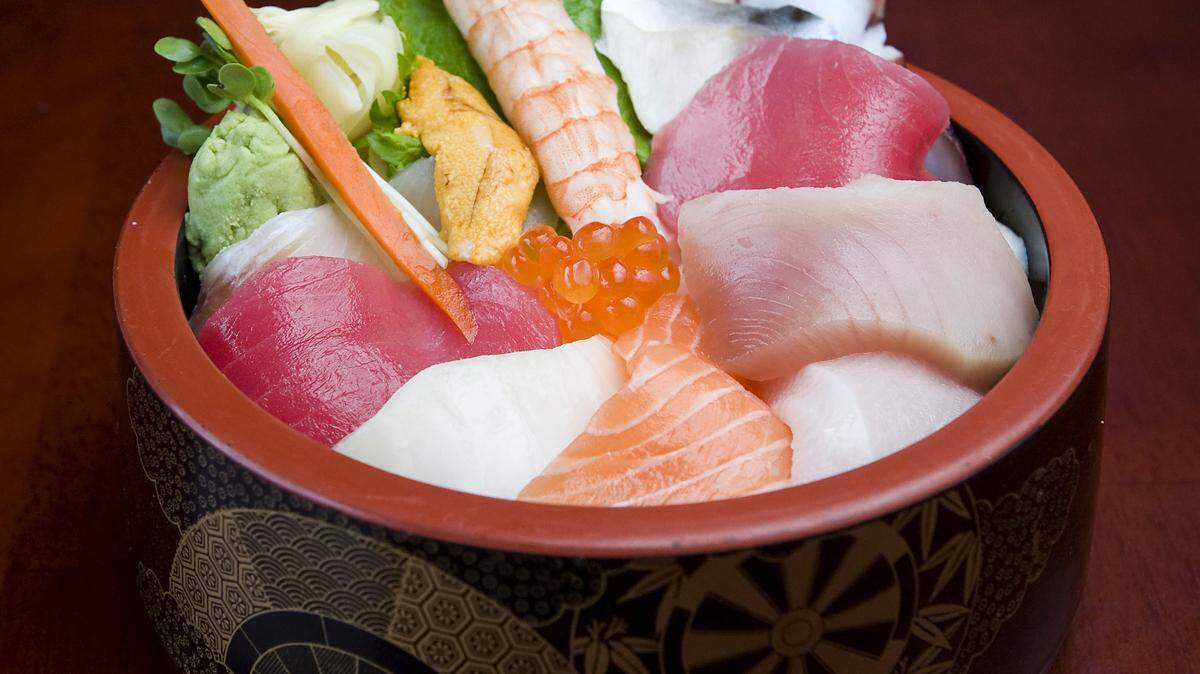 Chirashi Zushi features assorted sashimi over rice.