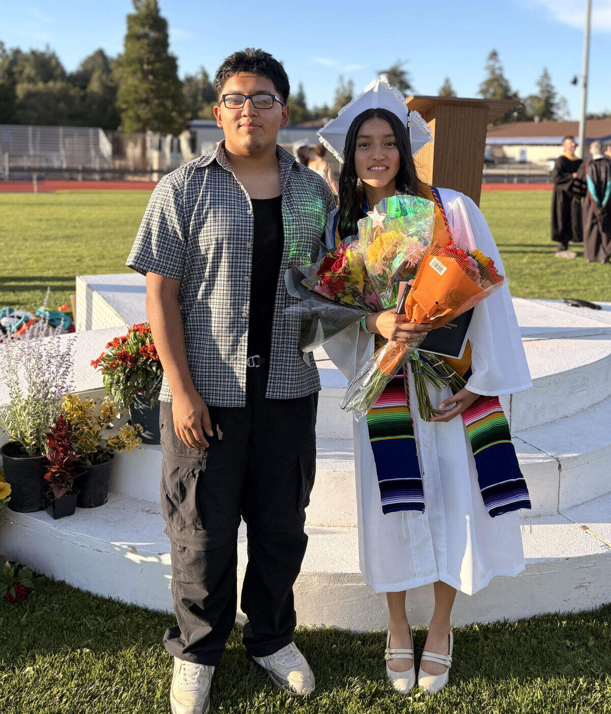 Victor Bahena, owner of the Cambria New Diner, poses with his daughter, Jazmin Bahena, after her high-school graduation on June 11, 2026.