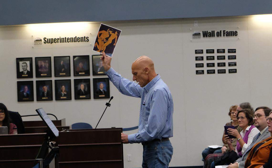 Paul Masters holds up an image from a book he wanted banned, during a discussion at a Lucia Mar school board meeting on Nov. 18, 2025. The school board voted to retain the books “Gender Queer" and “Push” in the Arroyo Grande High School library.