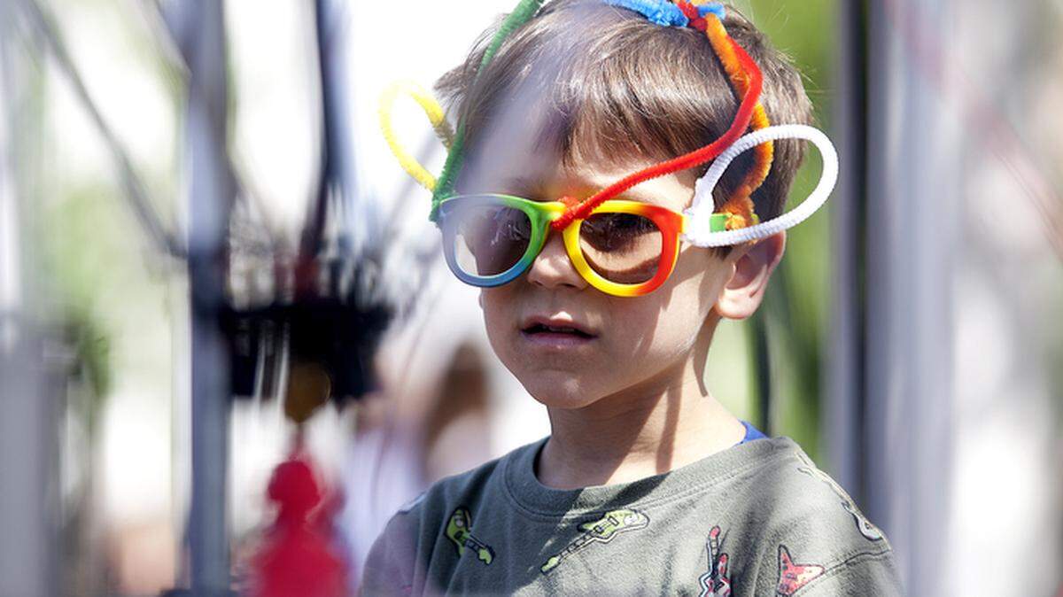 Donning a pair of silly sunglasses, Jonah Sullivan, 5, Atascadero, watches a 3-D printer "sculpt" an object at the Mini Maker Faire on Saturday.