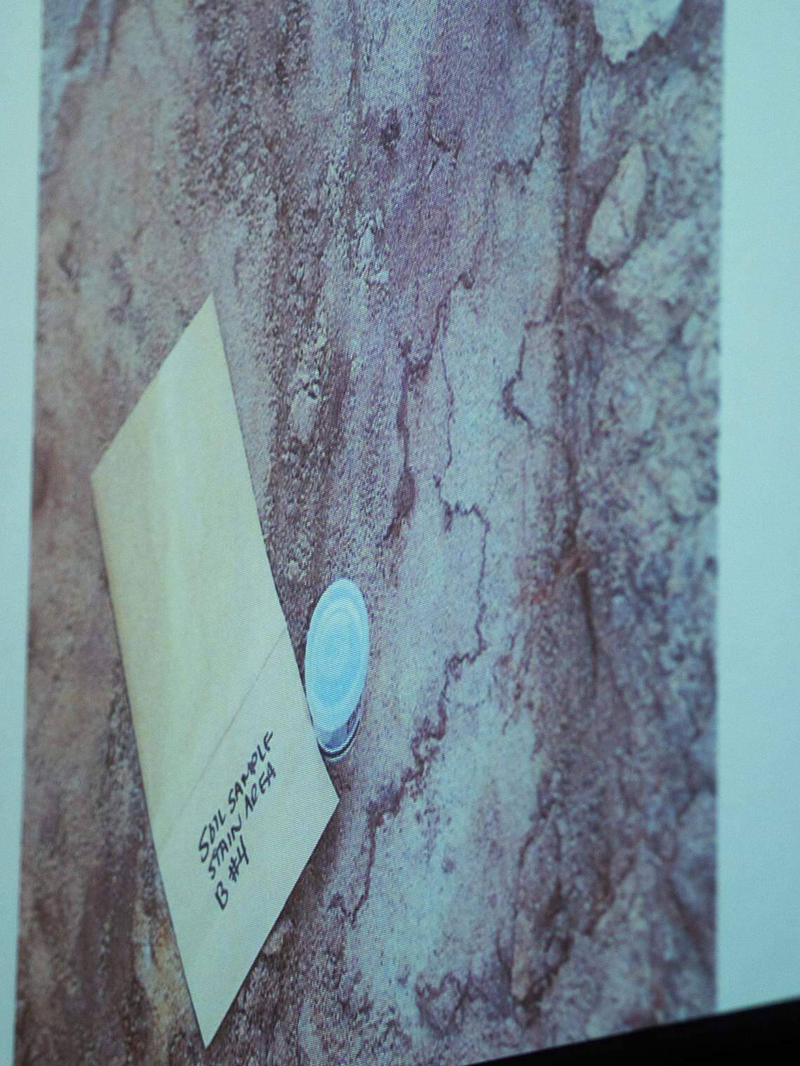 A photo of a soil stain underneath Ruben Flores’ deck is shown to jurors during the Kristin Smart murder trial at Monterey County Superior Court in Salinas on Wednesday, Sept. 21, 2022.