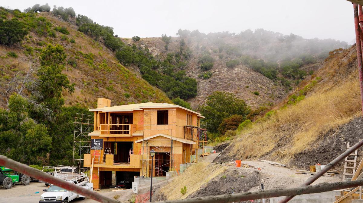 Several three-story homes in the Barcelona Point are set into the landscape of the mountains that border Pismo Beach to the east, pictured here Tuesday, July 1, 2025. The development is nestled into the base of the mountains that border Pismo Beach to the east, requiring some home lots to be leveled and reinforced prior to building.