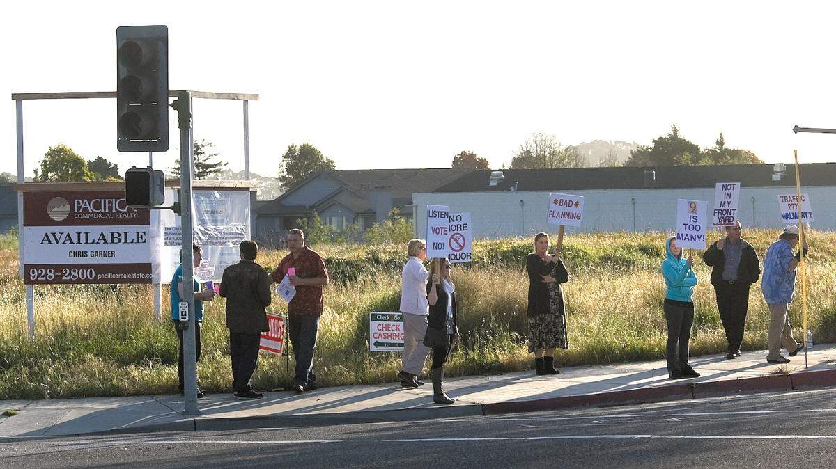 Protesters with signs rally against a proposed shopping center development Thursday, March 3, 2011, at South Courtland Street and East Grand Avenue in Arroyo Grande.