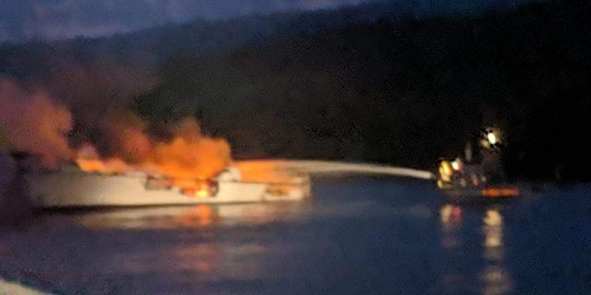 Santa Barbara Harbor Patrol Boat 3 sprays water on the Conception, which was burning out of control when first responders arrived on the scene off Santa Cruz Island. 