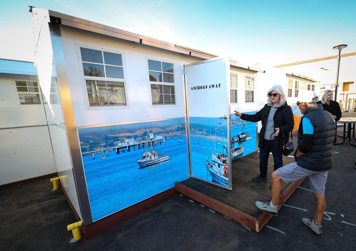 5Cities Homeless Coalition gives a tour of its Cabins for Change program in Grover Beach on Dec. 15, 2022. The South County transitional housing project features 20 100-square-foot pallet shelters. Vivian Krug-Cotton donated the photographs used to personalize the cabin exteriors.