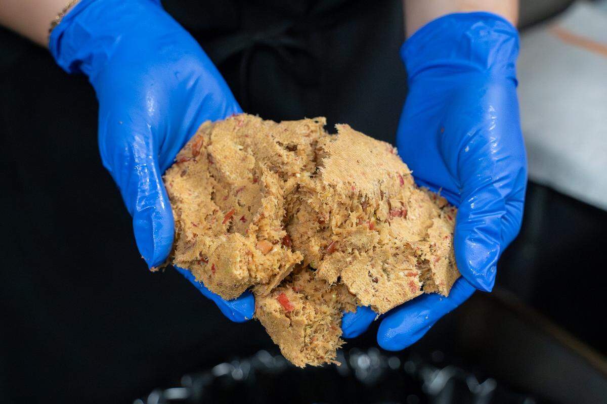 SLO Pressed owner Briana Medvecki holds a handful of pulp in the kitchen at CaliPaso in San Luis Obispo on Thursday, May 14, 2026. Pulp and other produce scraps are sent to a local farmer, who mixes it into his pig feed.