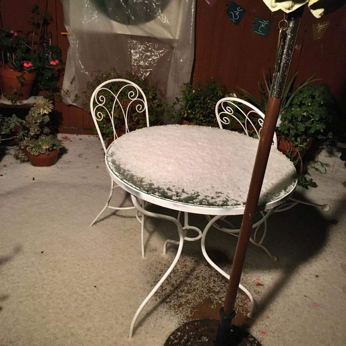 Hail covers a table in a courtyard of the Battistone/Edgerly Apartments in downtown Santa Barbara.