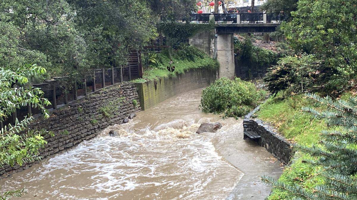 A swollen San Luis Creek runs through downtown during winter storm on Feb. 16, 2026.