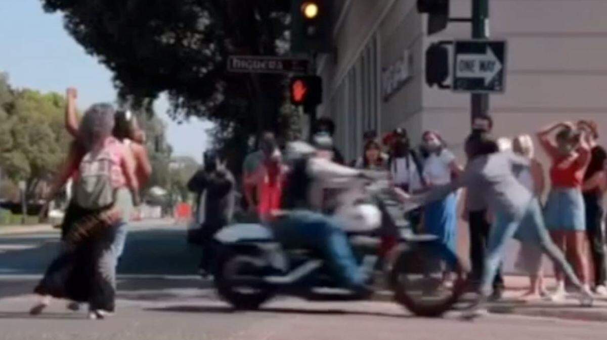 A motorcyclist drives into Black activists protesting on Higuera Street in San Luis Obispo on Sept. 2.
