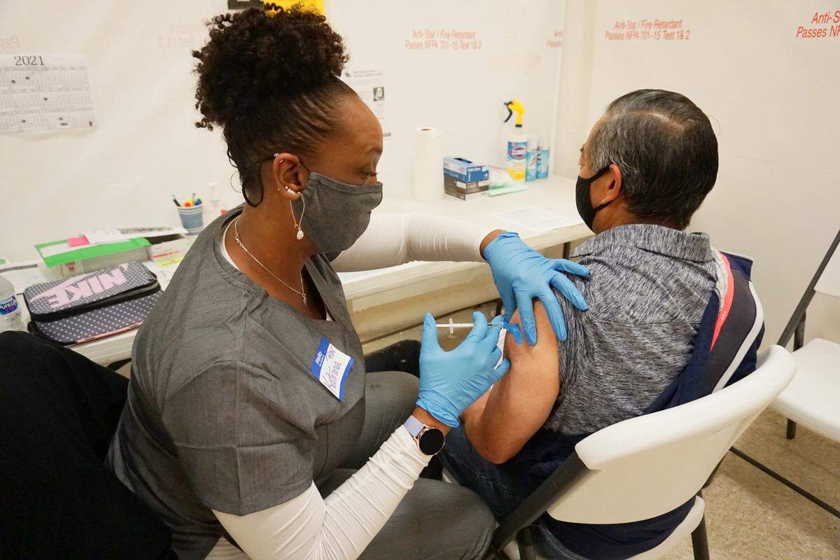 A health care worker administers the COVID-19 vaccine to a San Luis Obispo County agriculture worker at a special clinic in Arroyo Grande on Friday, March 19, 2021.