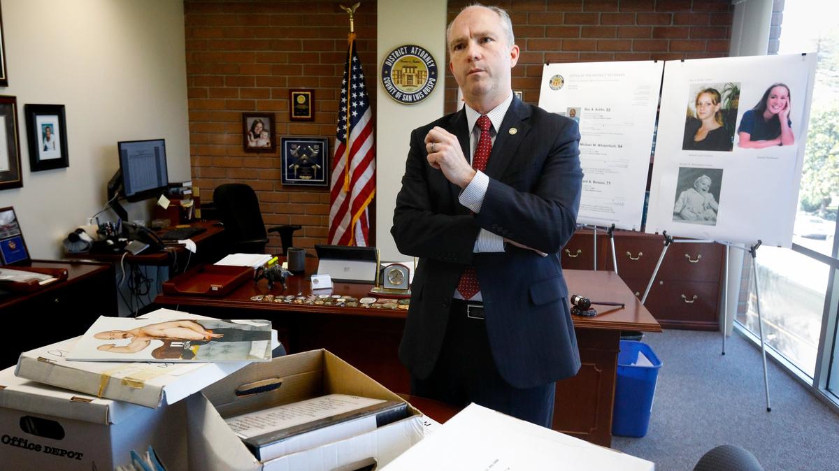 San Luis Obispo County District Attorney Dan Dow looks over some of the boxes of evidence from the Rex Krebs murder case in a 2019 photo.