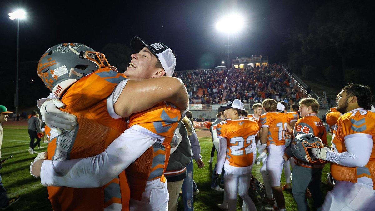 Anthony Tejada left and C.J. Bell hug as the Greyhounds celebrate. Atascadero High School beat Pioneer Valley 27-13 to win the Division V, 2022 CIF Central Section Football Championships Nov. 25, 2022.