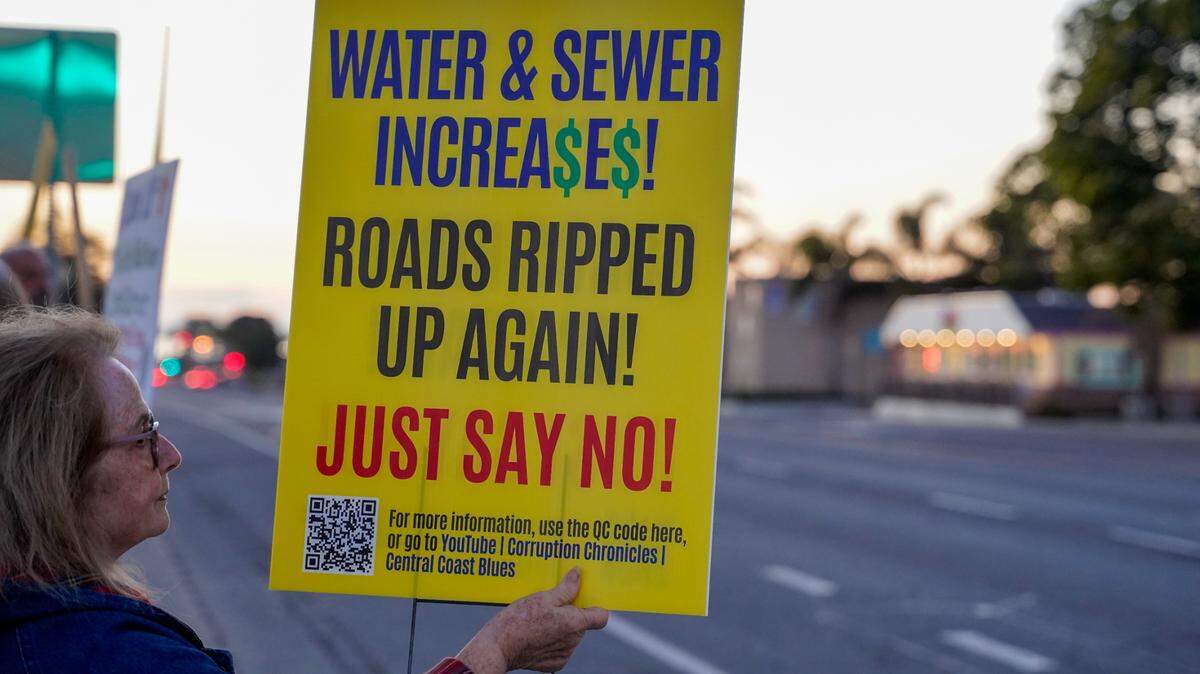 Grover Beach residents protest a proposed 91.8% water rate increase over the next five years, before the Grover Beach City Council meeting on Nov. 13, 2023.