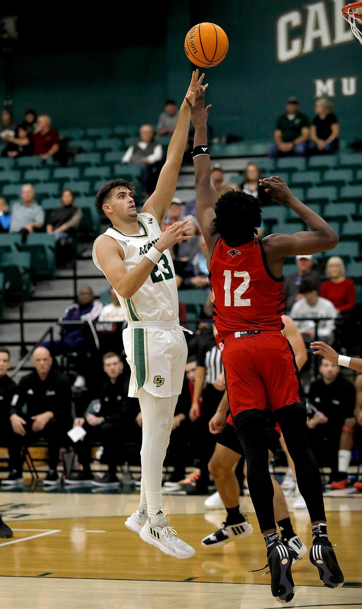 Cal Poly’s Ethan Menzies shoots over Seattle’s Matthew-Alexander Moncrieffe. Cal Poly beat Seattle University 75-71 in a college basketball game at Mott Athletics Center on Nov. 14, 2024.