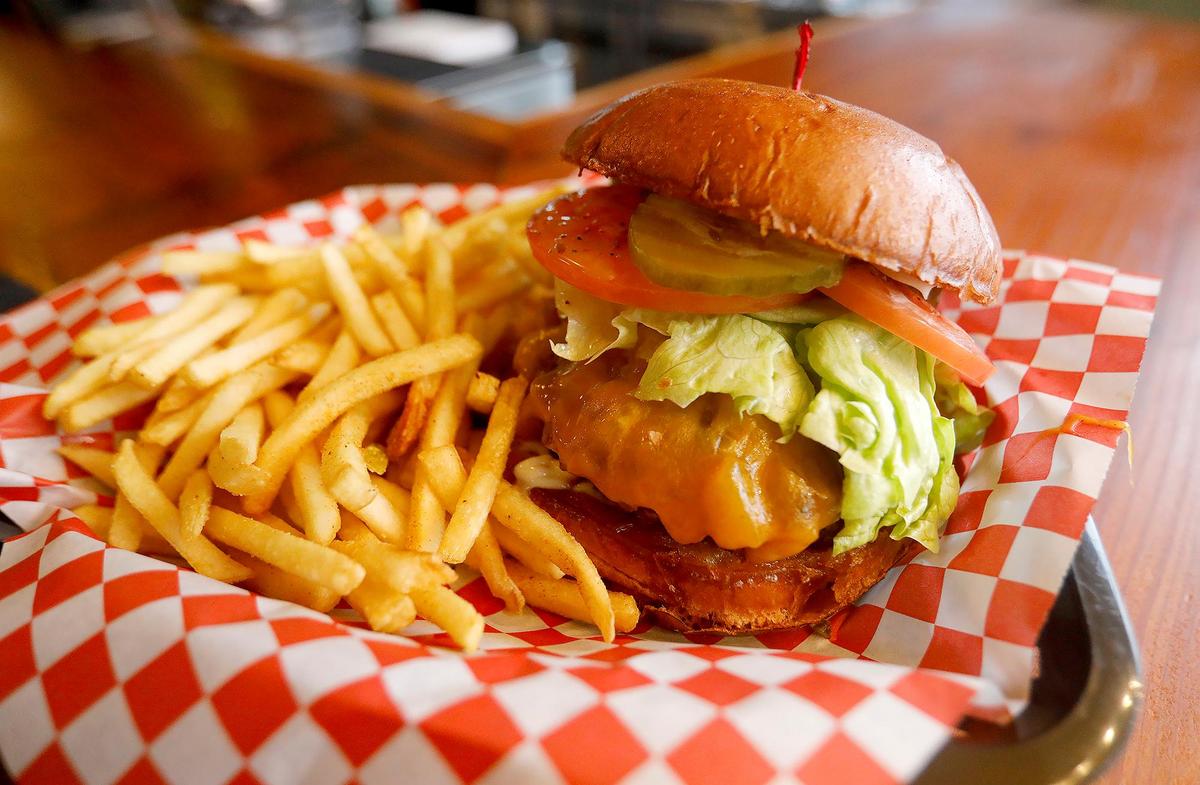 This is Sammy J’s “J’s Burger”. It’s a quarter-pound patty, cheddar, sauteed onions, lettuce, tomato, mayo and bacon jam.