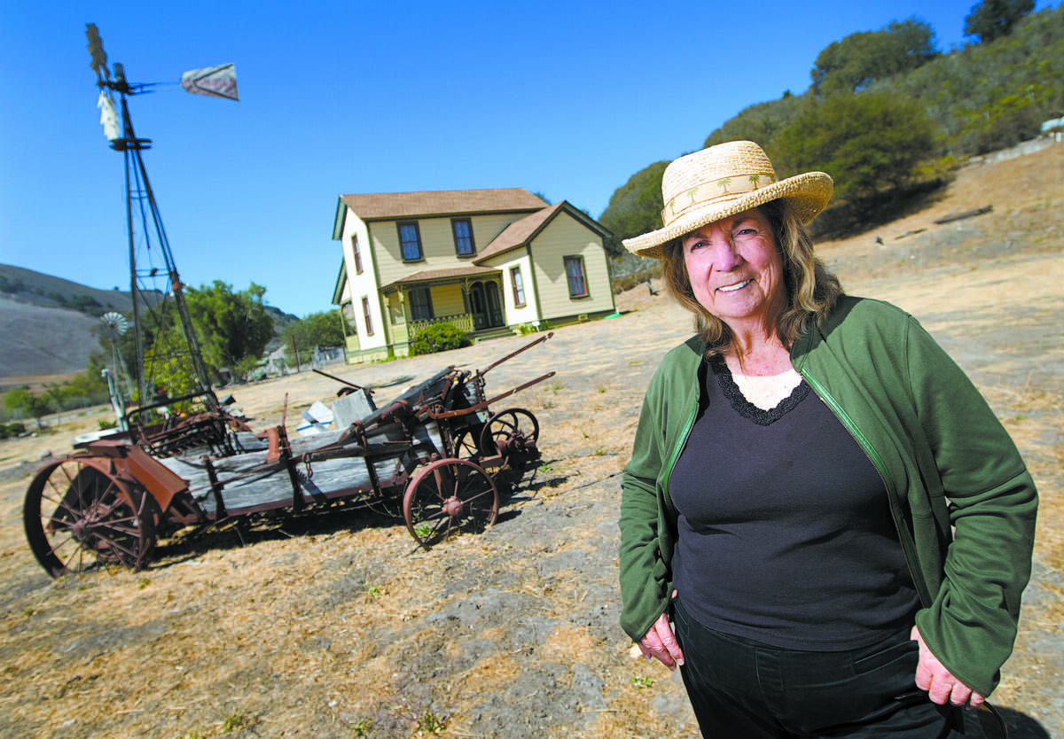 Effie McDermott, president of Friends of Price House, poses for a photo near the historical Pismo Beach house in August 2014.