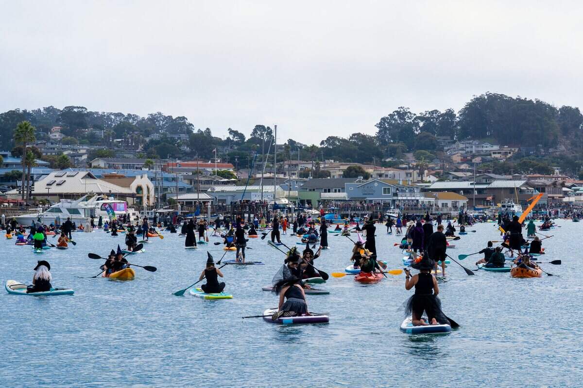 Hundreds of witches take to the harbor at the Witches Paddle in Morro Bay on Saturday, Oct. 25, 2025. The 13th annual paddle attracted hundreds of witches and creatures of the night taking to the watter on paddleboards, kayaks and other small craft.