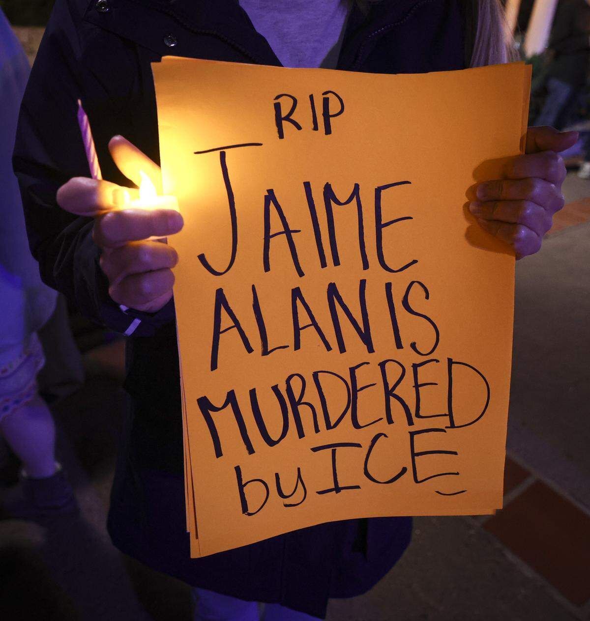 Sabrina (declined to give last name) holds a sign remembering a farmworker who fell from a greenhouse roof during a chaotic ICE raid in Camarrilo. About 200 people gathered in Mission Plaza on Jan. 8, 2026 to protest recent detentions or arrests of 1,400 people by ICE and nationally the recent shootings by federal agencies. 