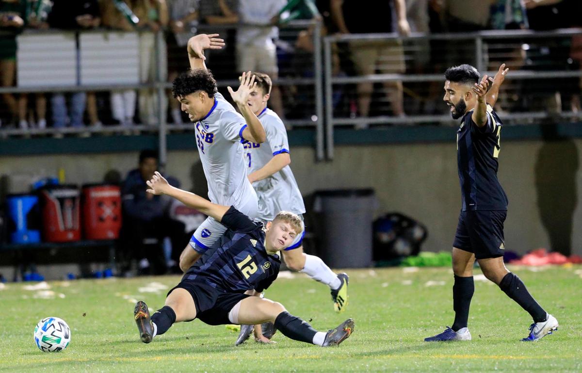 Cal Poly’s Daniel Normann (12) battles for the ball against two UCSB players in the Blue-Green Rivalry game on Oct. 16, 2021, at Alex G. Spanos Stadium in San Luis Obispo. After two overtime periods, the game ended in 0-0 draw.