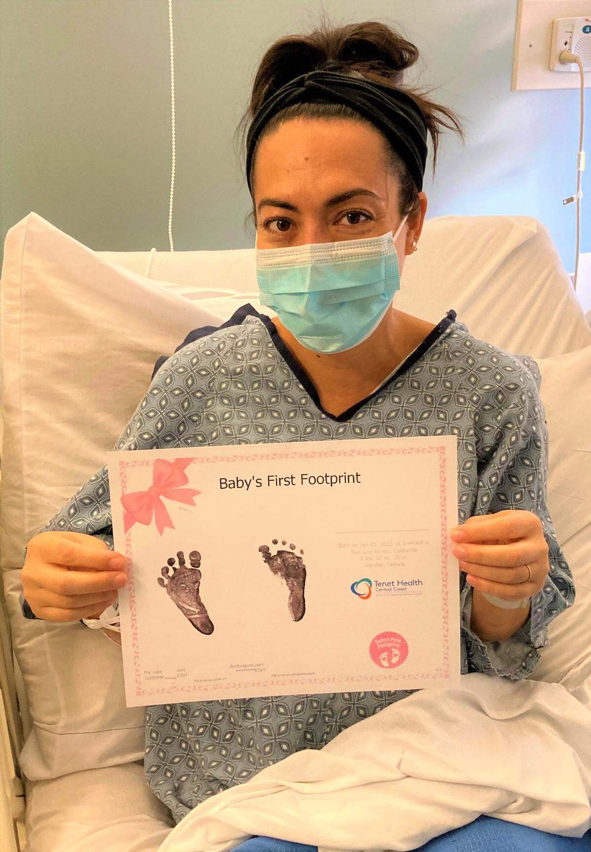 New mom Kelsey Bilsten holds up the footprints of her daughter, Blake Charlotte Bilsten. Baby Bilsten was the first baby born in San Luis Obispo County on New Year’s Day in 2022.