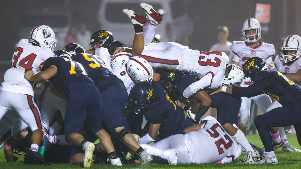 Derek Brockenborough scores despite a leaping attempt to stop him by Jackson Rede. Arroyo Grande beat Paso Robles 40-7 in a high school football game on Oct. 4, 2024.