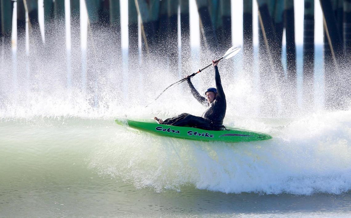 A kayaker successfully navigates a wave in Cayucos on Nov. 27, 2021.