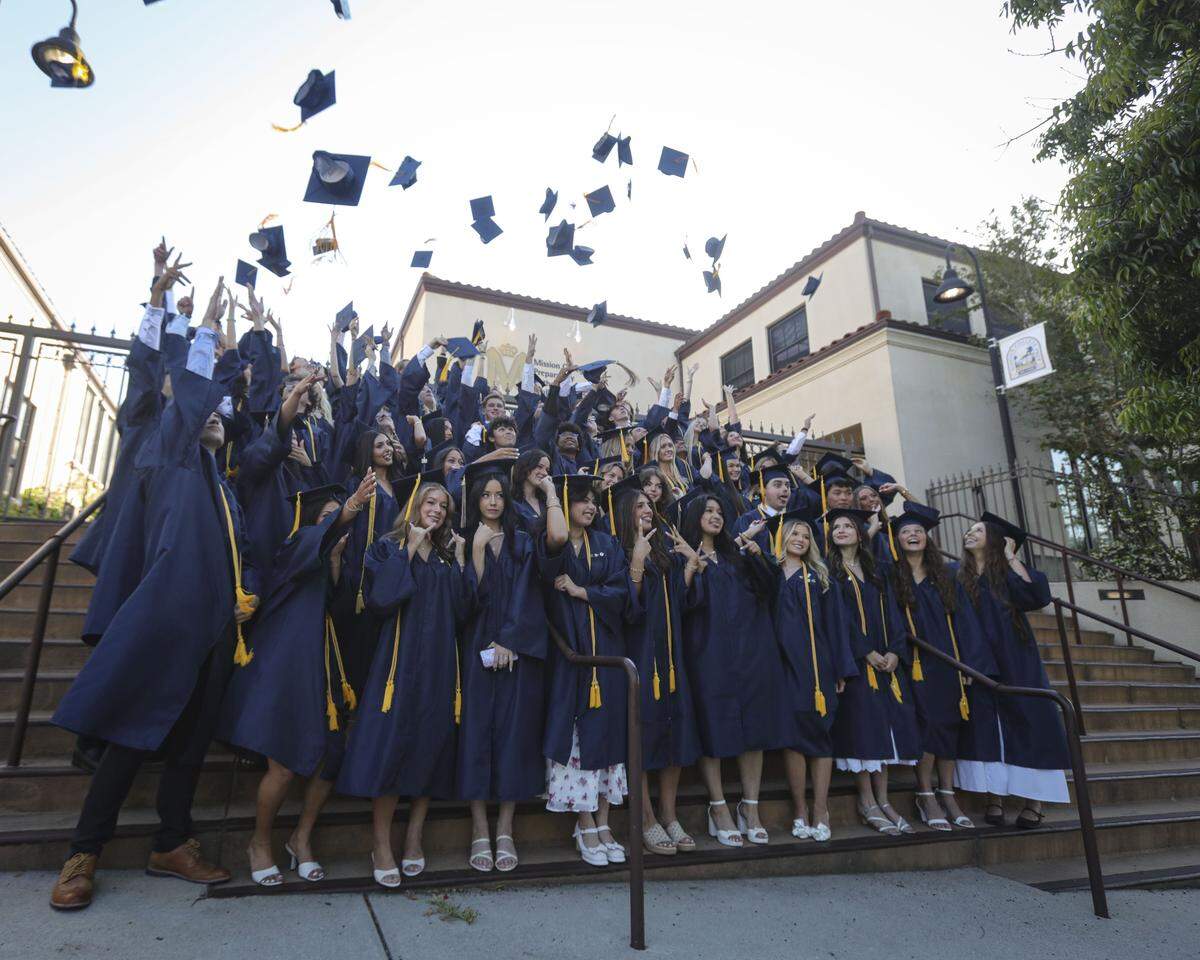 Students pose for a photo, some tossing caps and others making faces before leaving the school and walking to the ceremony. Mission Prep graduated 66 students in a ceremony at Old Mission San Luis Obispo on May 29, 2026.