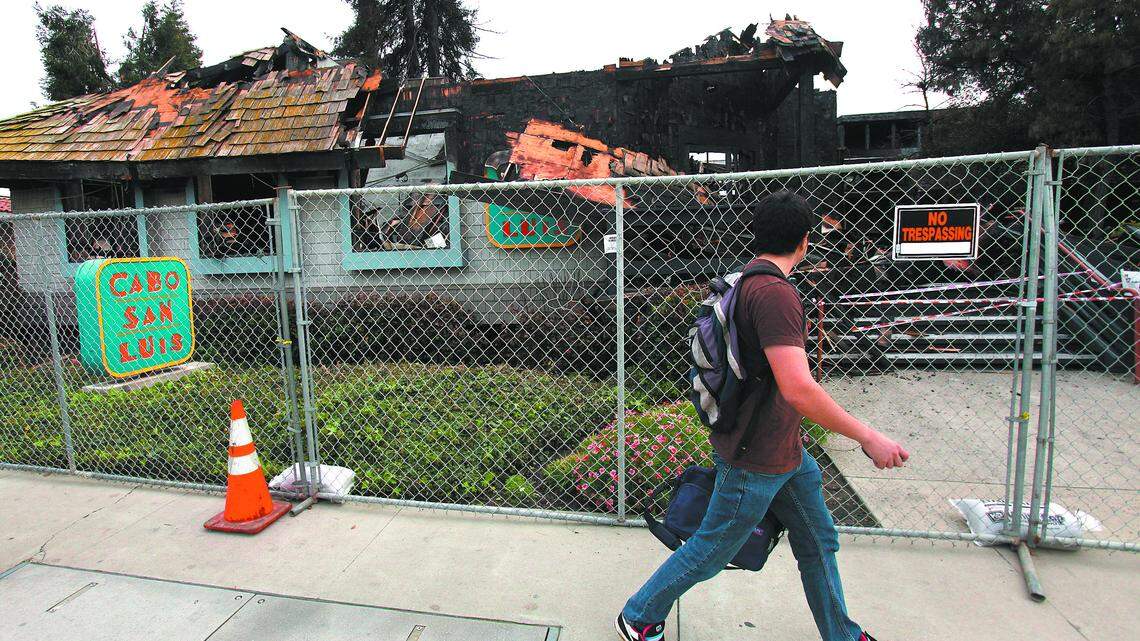 Charles Garciduenas walk past Cabo San Luis after fire destroyed the restaurant Wednesday morning. It was one of his favorite places to eat.  photo Jayson Mellom 3-05-10