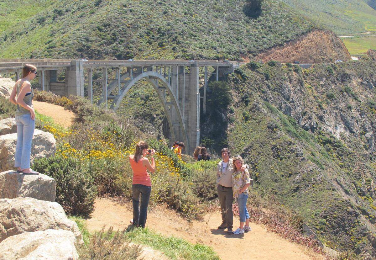 Tourists pose for photographs at Bixby Bridge in Big Sur, California.