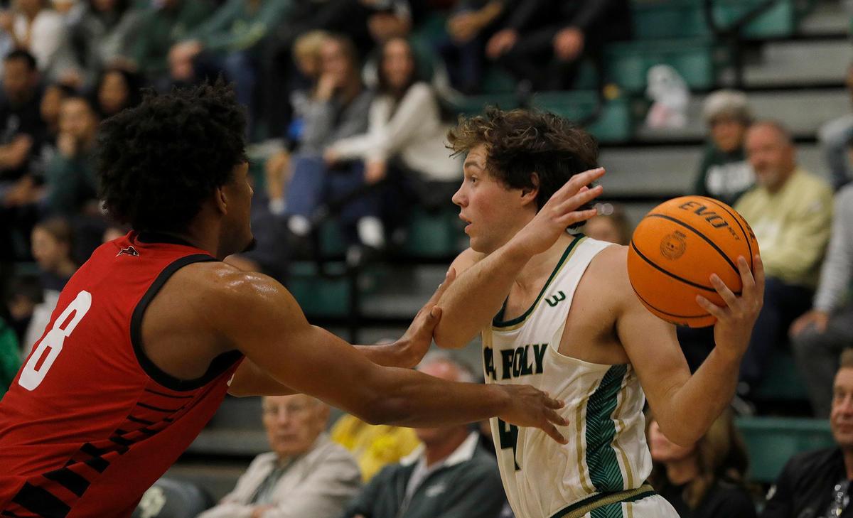 Cal Poly’s Kieran Elliot and Seattle University’s Elliott Malek Gomma battle for the ball. Cal Poly beat Seattle University 75-71 in a college basketball game at Mott Athletics Center on Nov. 14, 2024.