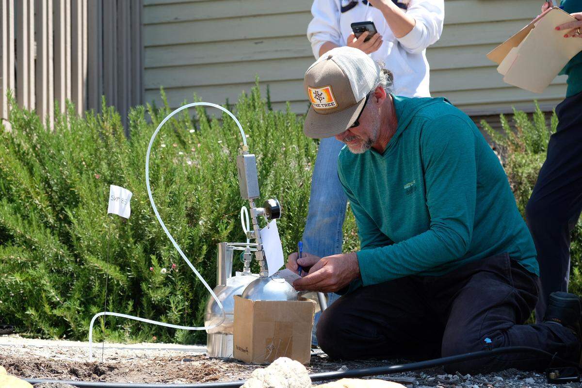 Environmental engineer Timothy Nelligan test the soil in the front yard of the house next door to Susan Flores’ home in Arroyo Grande on Thursday, May 7, 2026, during the second day of a search warrant investigation in the Kristin Smart murder case.