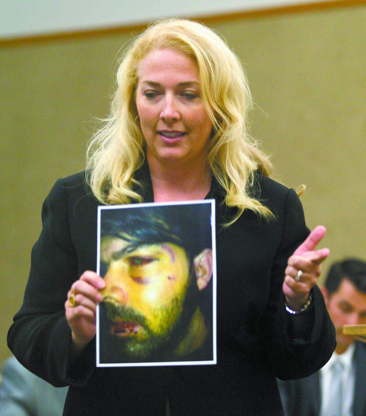 Deputy District Attorney Kristy Imel holds a photo of Jory Brigham, who suffered a broken nose, broken jaw and broken cheekbones during a June 2011 altercation at Pappy McGregor’s Bar & Grill in San Luis Obispo during the 2012 trial of John Mason, charged with the assault. Imel was appointed to fill a judicial vacancy in Santa Barbara County.