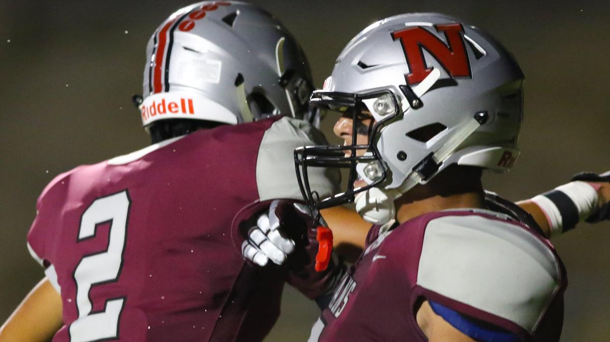 Jesse Garza, right, celebrates the first touchdown of Nipomo High School’s game Friday night against Cabrillo. The game was played at SLO High as Nipomo’s stadium is under construction.