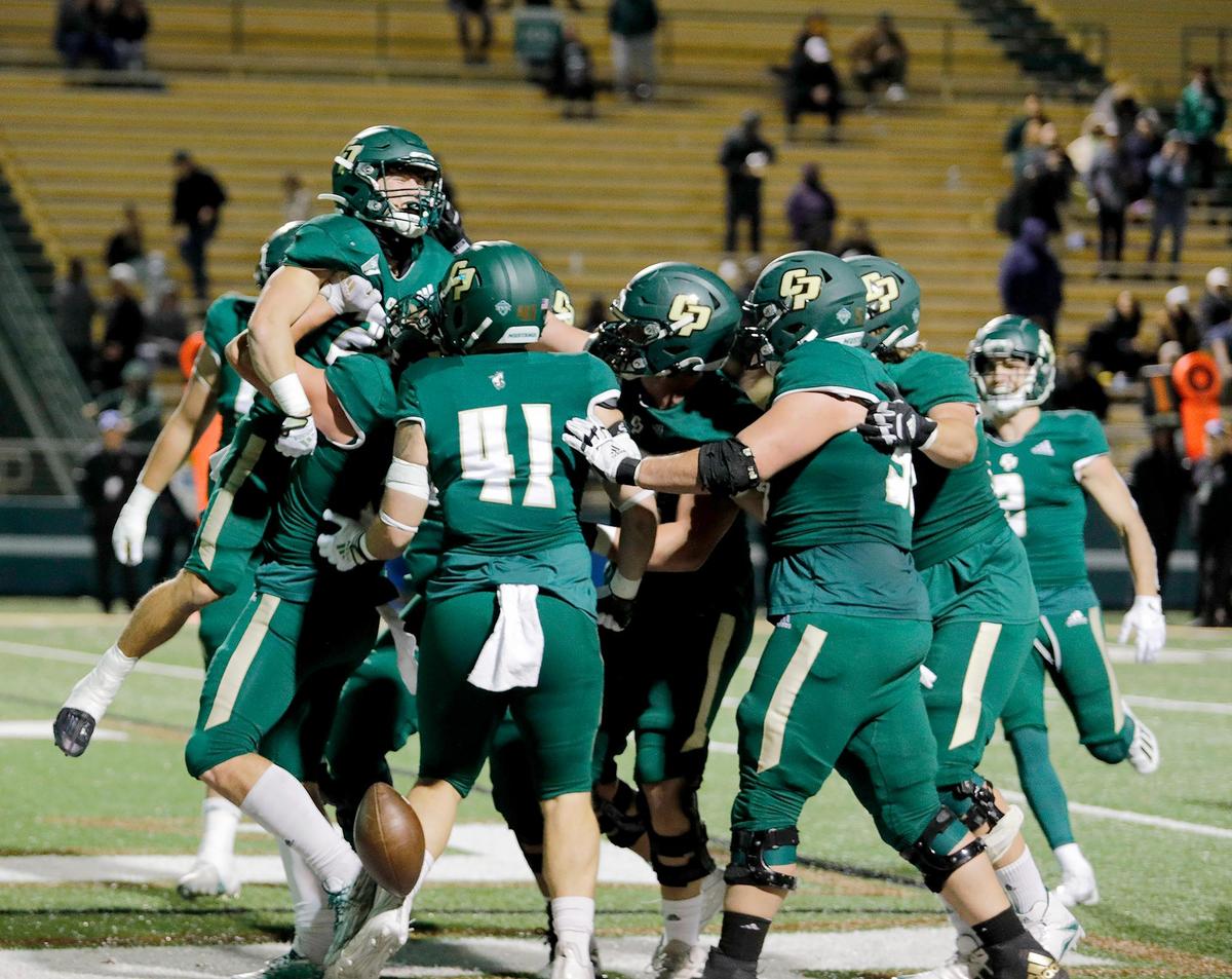 Mustang Troy Fletcher (28) is lifted up by his teammates after scoring a touchdown. Cal Poly beat Portland State 49-42 to earn their first and only Big Sky win of the season on Saturday, Nov. 19, 2022, at Alex G Spanos Stadium in San Luis Obispo.