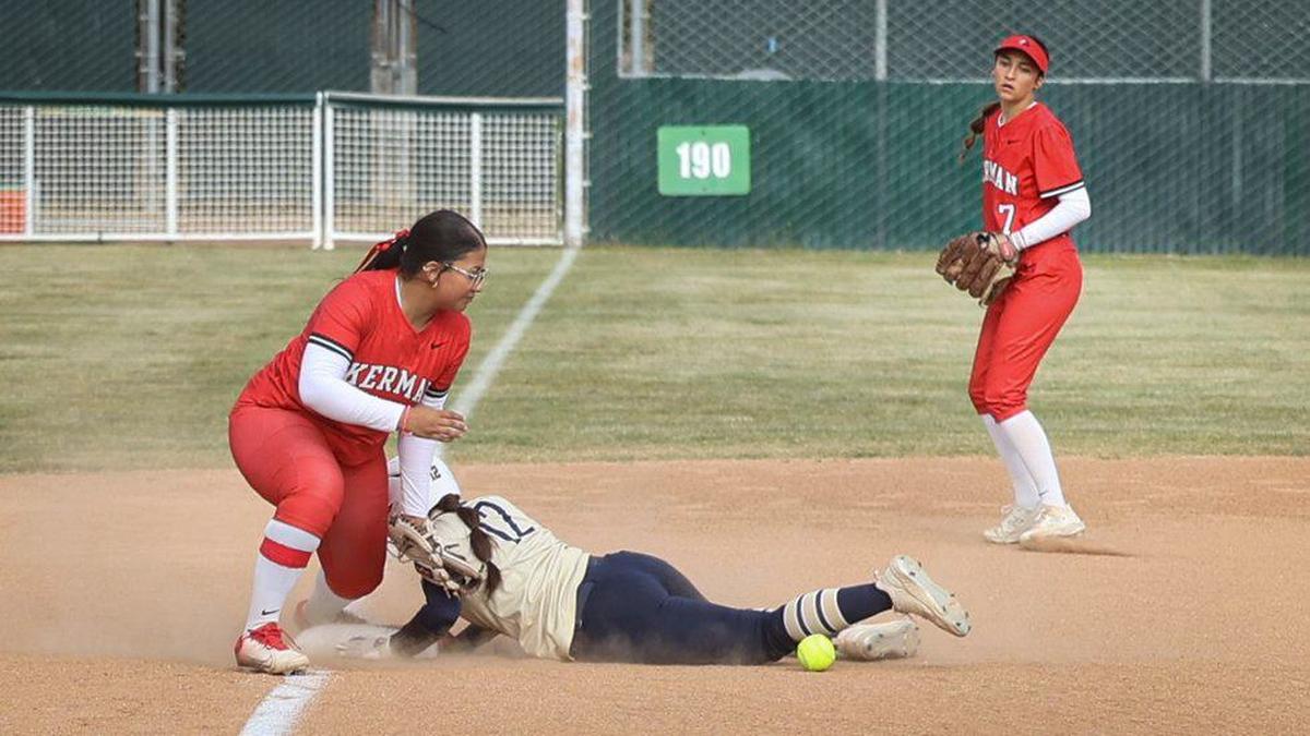 Samantha Rodriguez takes third as throw gets away from Jayanna Gonzales. Mission Prep won 2-0 over Kerman in a softball playoff May 22, 2024.