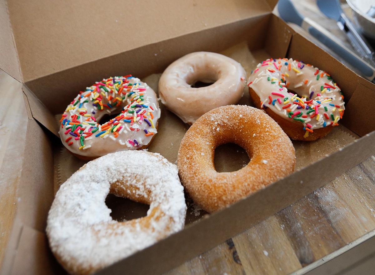Ben and Jessica Brown acquired a shuttered former fish smokehouse in Cayucos and transformed it into a new, eye-catching doughnut shop, Surf Rats Donuts. A box of freshly made doughnuts.