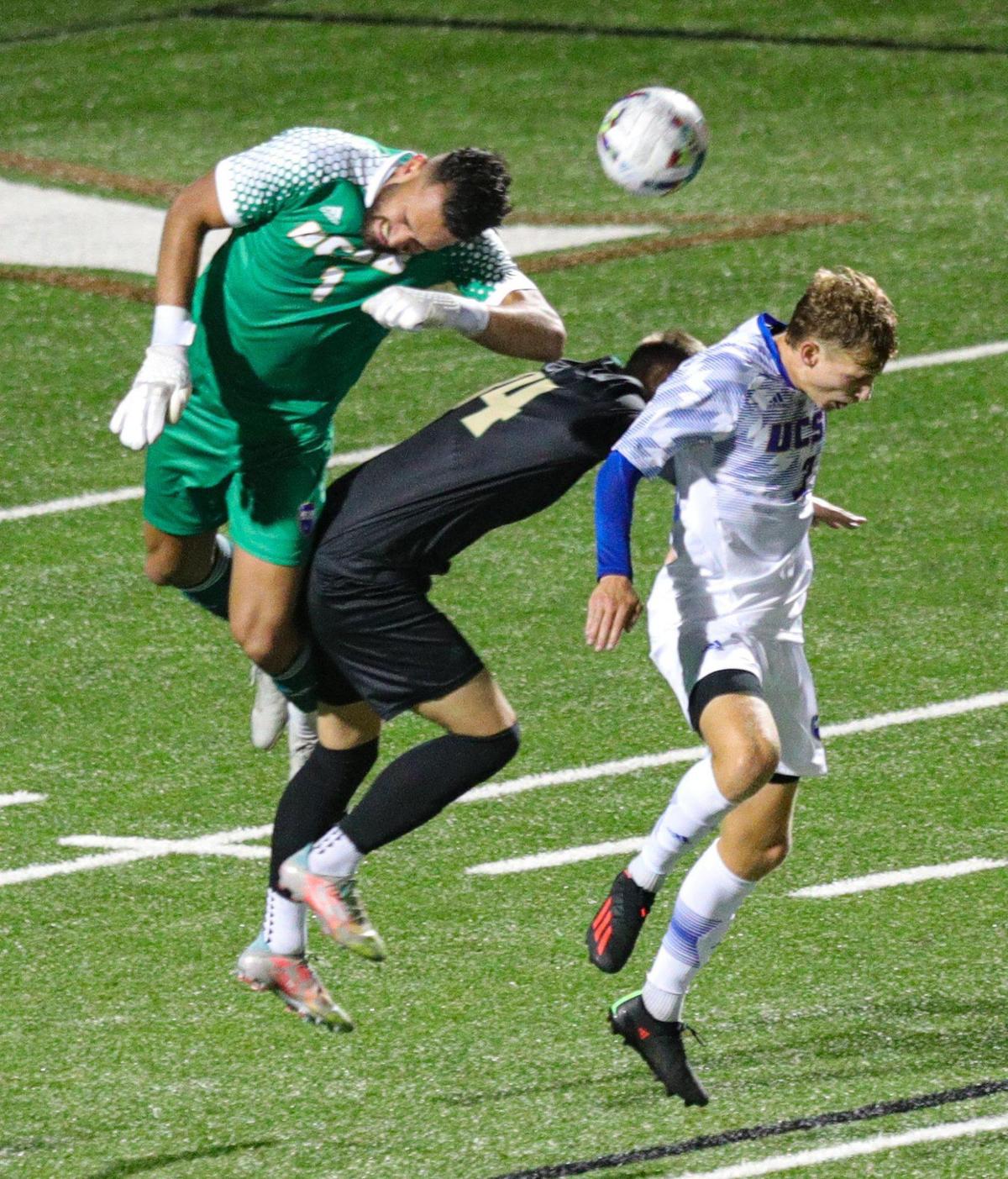 UCSB keeper Leroy Zeller was called for a penalty with an elbow to Isak Clausen. Henry Davis is at right.