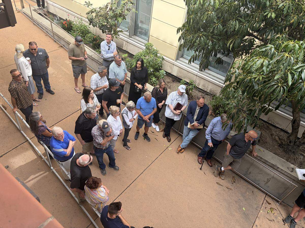 A crowd of roughly 43 people gathered in the breezeway and balconies at the SLO County Central Services Building at 1087 Santa Rosa St. in downtown San Luis Obispo to witness the auction of the F. McLintocks Saloon and Dining House building on March 24, 2026.