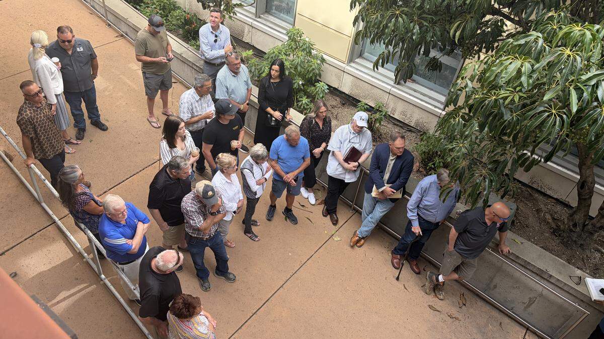 A crowd of roughly 43 people gathered in the breezeway and balconies at the SLO County Central Services Building at 1087 Santa Rosa St. in downtown San Luis Obispo to witness the auction of the F. McLintocks Saloon and Dining House building on March 24, 2026.